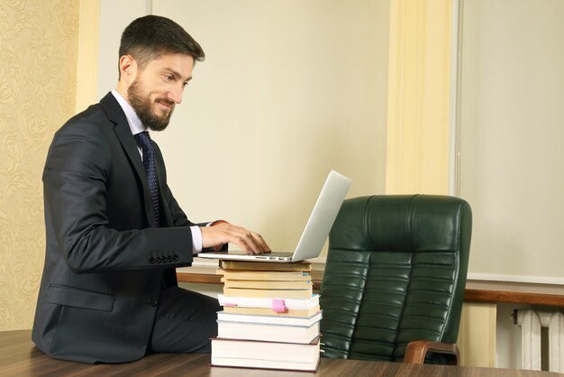 hombre-negocios-exitoso-oficina-trabajando-ordenador-portatil_158518-3013